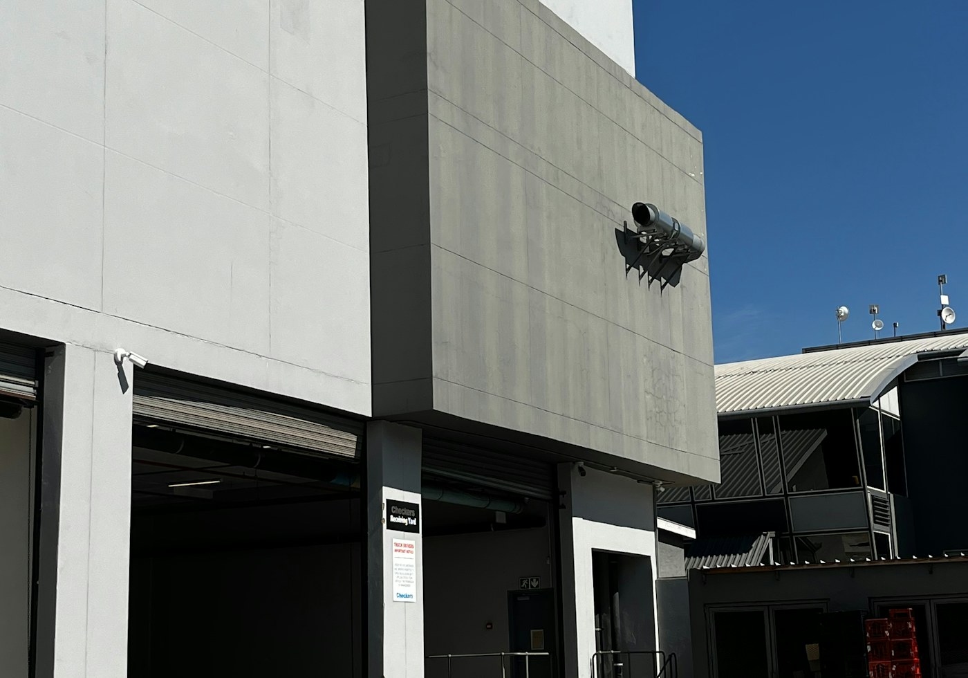 Standalone industrial facility with loading bays under a clear sky